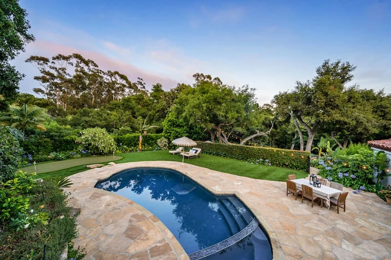 a-backyard-with-a-swimming-pool-and-trees-plants